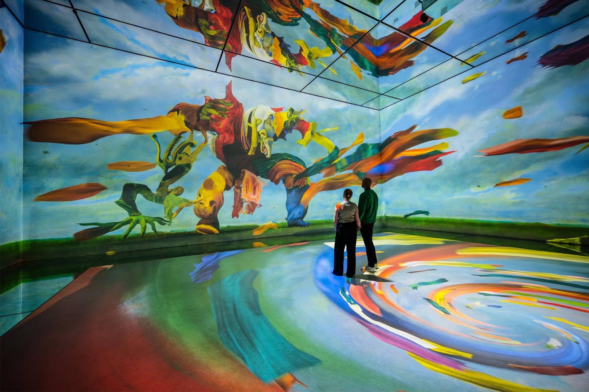 A projected painting filling the walls and floor of an immersive gallery
